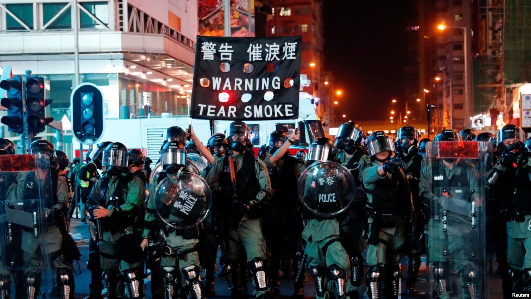 Riot police hold up a banner warning protesters about tear gas during anti-government protest in Hong Kong, China October 20, 2019. 