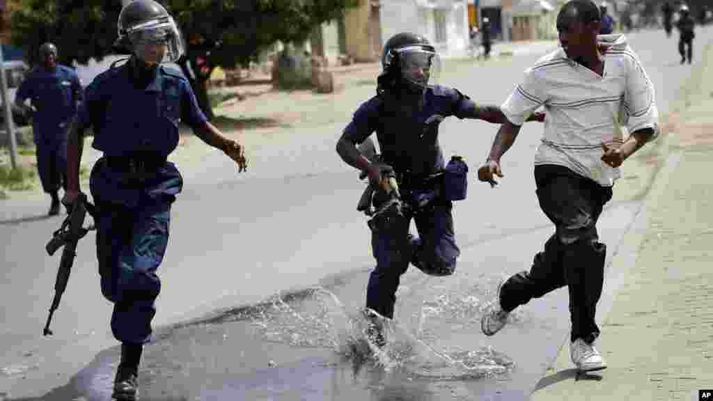 La police anti-émeute pourchasse un manifestant à Bujumbura, Burundi, lundi 4 mai 2015.