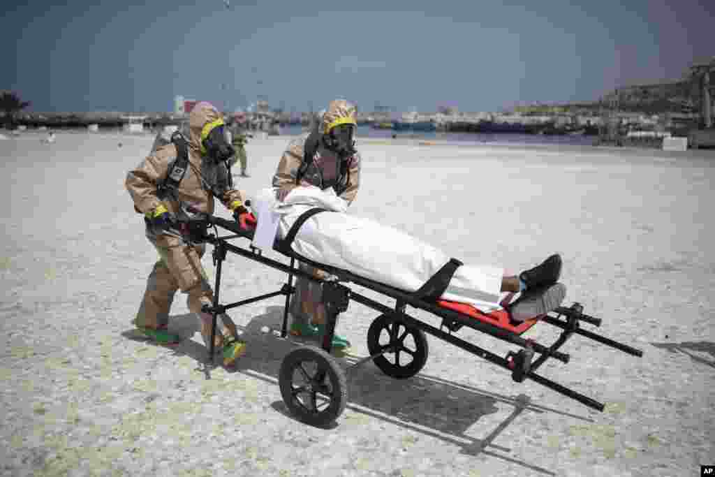 Members of the Moroccan Royal Armed Forces Rescue & Relief Unit take part in a biochemical simulation organized by the U.S, Defense Threat Reduction Agency (DTRA) as part of an African Lion military exercise, in the port of Agadir, southern Morocco.