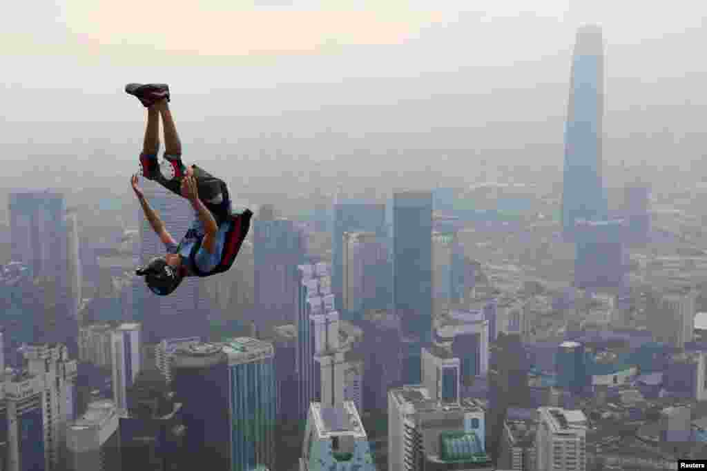 A BASE jumper leaps from Kuala Lumpur Tower on a hazy day during International Jump Malaysia 2019 in Kuala Lumpur, Malaysia.