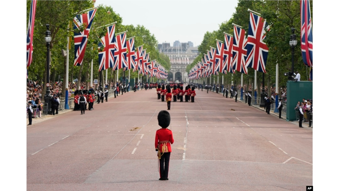 FILE - Troops marching down the Mall to Horse Guards parade to take part in the Trooping the Color parade at Buckingham Palace in London, June 17, 2023.