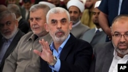 FILE - Yahya Sinwar, head of Hamas in Gaza, greets his supporters upon his arrival at a meeting in a hall on the sea side of Gaza City, on April 30, 2022.