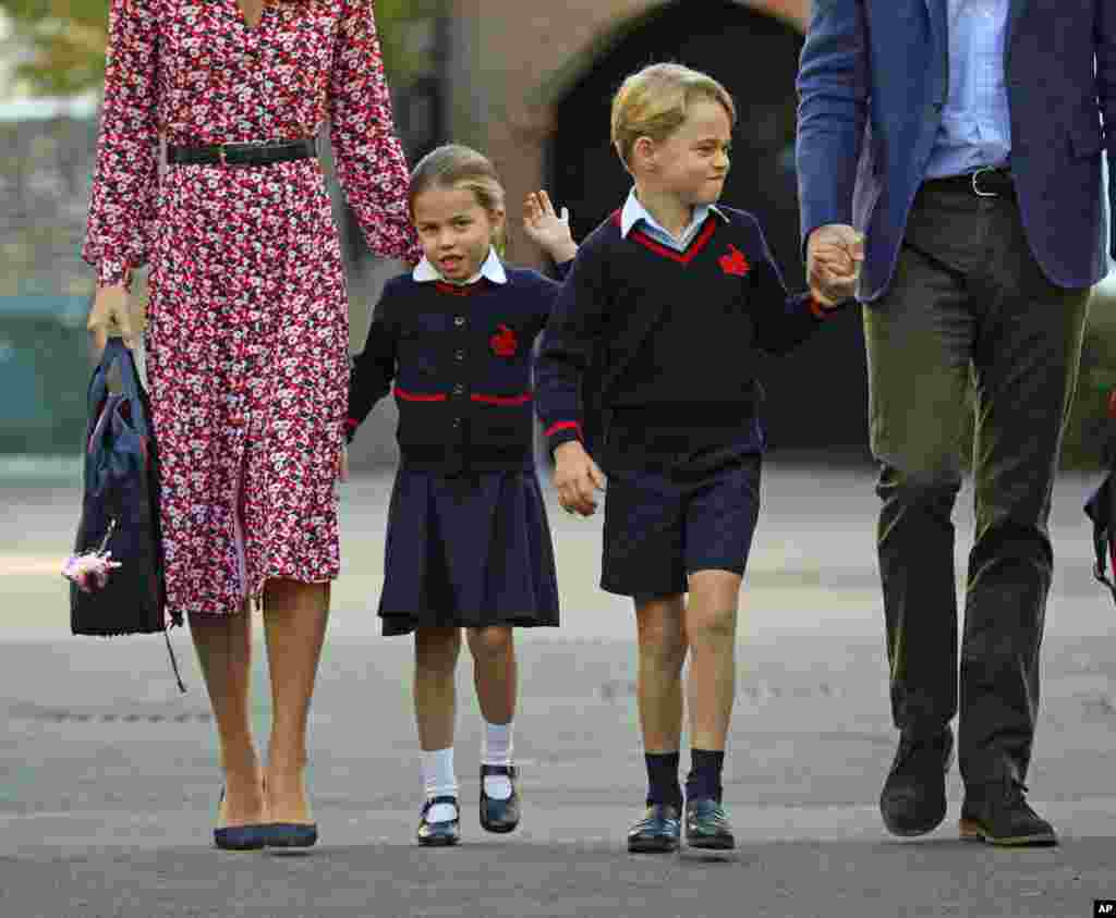 Britain's Princess Charlotte, left, with her brother Prince George and their parents Prince William and Kate, Duchess of Cambridge, arrives for her first day of school at Thomas's Battersea in London.