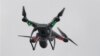 FILE - A drone hovers over the scene of an explosion that leveled two apartment buildings in the East Harlem neighborhood of New York, New York, March 12, 2014.