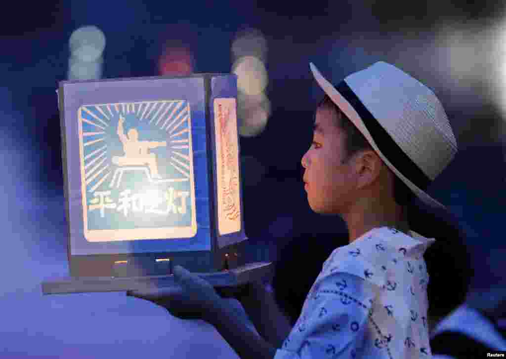 A boy holds a paper lantern in remembrance of victims of the 1945 atomic bombing on a day commemorating the 74th anniversary of the bombing in Nagasaki, western Japan. (Kyodo)