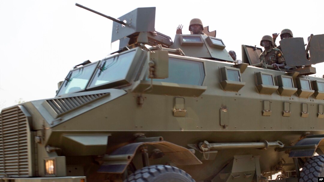 FILE - Soldiers from the Uganda People's Defense Force (UPDF) are seen driving in an armored vehicle through the streets of Bor, Jonglei State, South Sudan, Jan. 19, 2014.