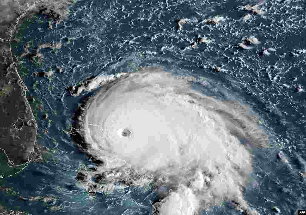 This satellite image obtained from NOAA/RAMMB shows Tropical Storm Dorian as it approaches the Bahamas and Florida at 12:00 UTC. Hurricane Dorian strengthened into a catastrophic Category 5 storm, packing 160 mph (267 kph) winds as it was about to slam into the Abaco Islands in the Bahamas, U.S. weather forecasters said.