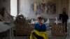 A boy helps salvage items at the Odesa Transfiguration Cathedral after it was heavily damaged in Russian missile attacks in Odesa, on July 23, 2023. (Jae C. Hong/AP)