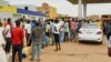 People gather to get fuel at a station, as clashes between the paramilitary Rapid Support Forces and the army continue, in south Khartoum locality, Sudan, April 30, 2023.
