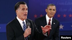 U.S. Republican presidential nominee Mitt Romney (L) answers a question as U.S. President Barack Obama looks on during the second U.S. presidential campaign debate in Hempstead, New York, October 16, 2012. 