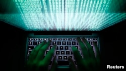 A man types on a computer keyboard in Warsaw in this Feb. 28, 2013 illustration file picture.