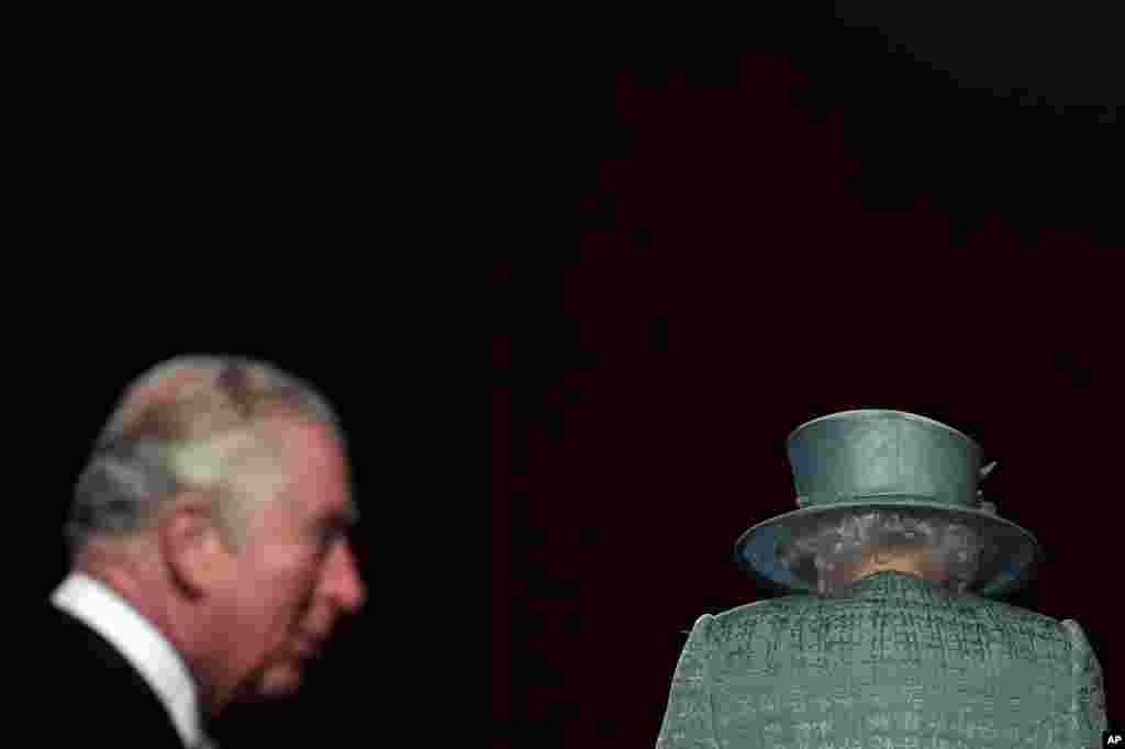 Britain's Queen Elizabeth and Prince Charles arrive for the State Opening of Parliament at the Houses of Parliament in London.