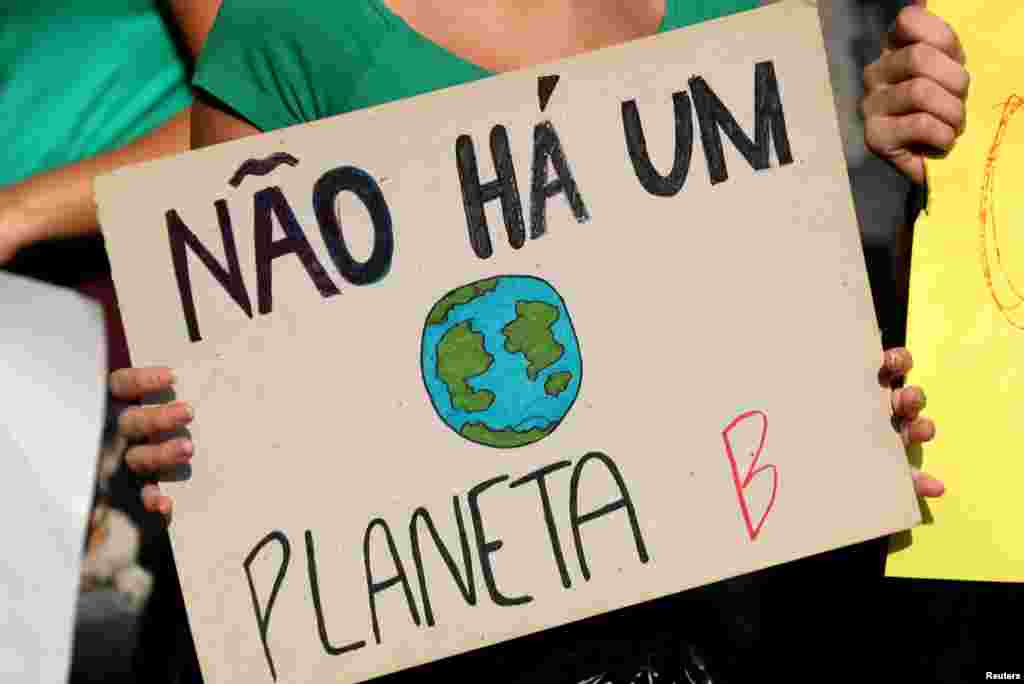 An attendee holds a sign which reads "There is no planet B" during the demonstration to demand more protection for the Amazon rainforest, in Rio de Janeiro, Brazi, Aug. 25, 2019.