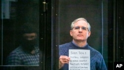 FILE - Paul Whelan, a former U.S. marine who was arrested for alleged spying, listens to the verdict in a courtroom at the Moscow City Court in Moscow, Russia, June 15, 2020. 