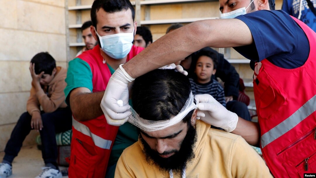 Medics treat civilians who were wounded at Raqqa's front line, at a mosque in Raqqa, Syria, Oct. 12, 2017. 