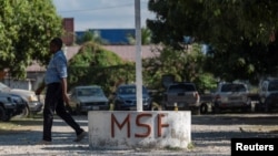 FILE - A man walks past a sign at a clinic run by Doctors Without Borders (MSF) in Port-au-Prince, Haiti, Feb. 3, 2023. MSF reported Nov. 13, 2024, that at least two patients were killed when its ambulance was attacked earlier this week in Port-au-Prince. 