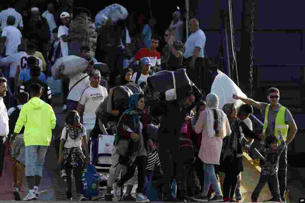 Refugees and migrants arrive at the port of Thessaloniki, northern Greece.