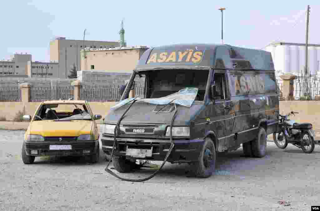 A Kurdish Security Forces vehicle is seen damaged from a suicide bombing in Qamishli, Nov. 25, 2013.