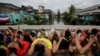 FILE - Filipino men place their hands over their heads as they are rounded up during a police operation in Manila on October 7, 2016, as part of the "War on Drugs" campaign by former Philippine President Rodrigo Duterte. (Aaron Favila/AP)