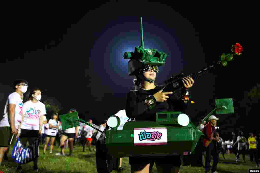 A runner dressed in a tank costume takes part in the "Run Against Dictatorship" event at a public park in Bangkok, Thailand.