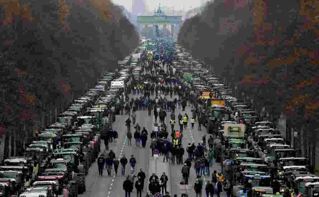 Farmers park their tractors on the 'Road of June 17' in front of the Brandenburg Gate in Berlin, Germany. Some thousands farmers are expected in the capital for a protest against the German and European agriculture policy.