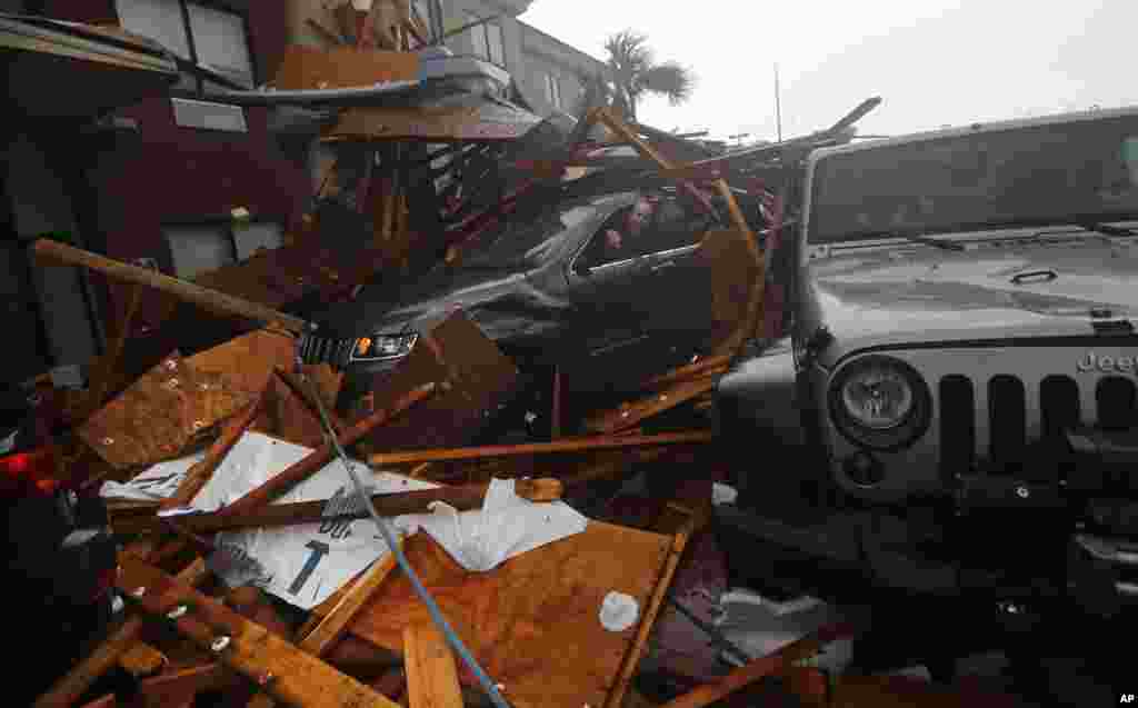 A storm chaser climbs into his vehicle during the eye of Hurricane Michael to retrieve equipment after a hotel canopy collapsed in Panama City Beach, Florida, Oct. 10, 2018.