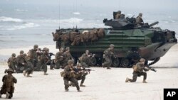 U.S. Marines with Amphibious Assault Vehicles take a part in a landing operation during Exercise Baltops 2018 along the Baltic Sea near the Lithuania village of Nemirseta, June 4, 2018. The U.S.-led exercise features 18,000 soldiers from 19 primarily NATO countries.