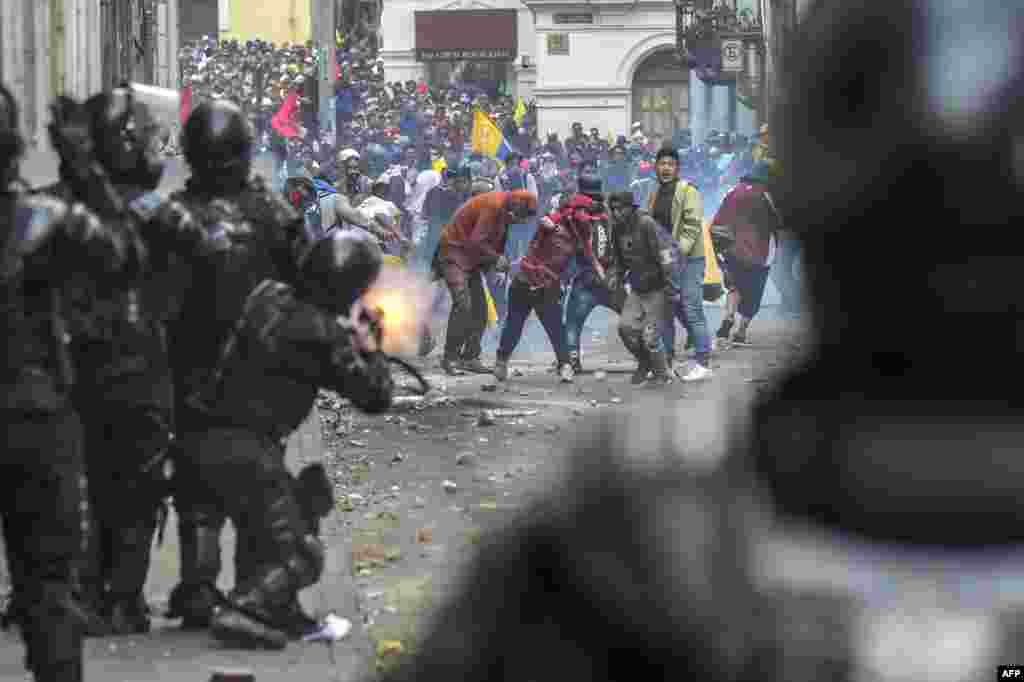 Demonstrators clash with riot police as thousands march against Ecuadorean President Lenin Moreno's decision to slash fuel subsidies, in Quito.