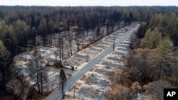 FILE- Homes were leveled by the Camp Fire line the Ridgewood Mobile Home Park retirement community in Paradise, Calif., Dec. 3, 2018.
