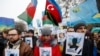 Ukrainian and Crimean Tatar activists hold portraits with the names of victims of the Russian annexation of Crimea during a rally in Kyiv on February 26, 2017. (Sergei Chuzavkov/AP) 