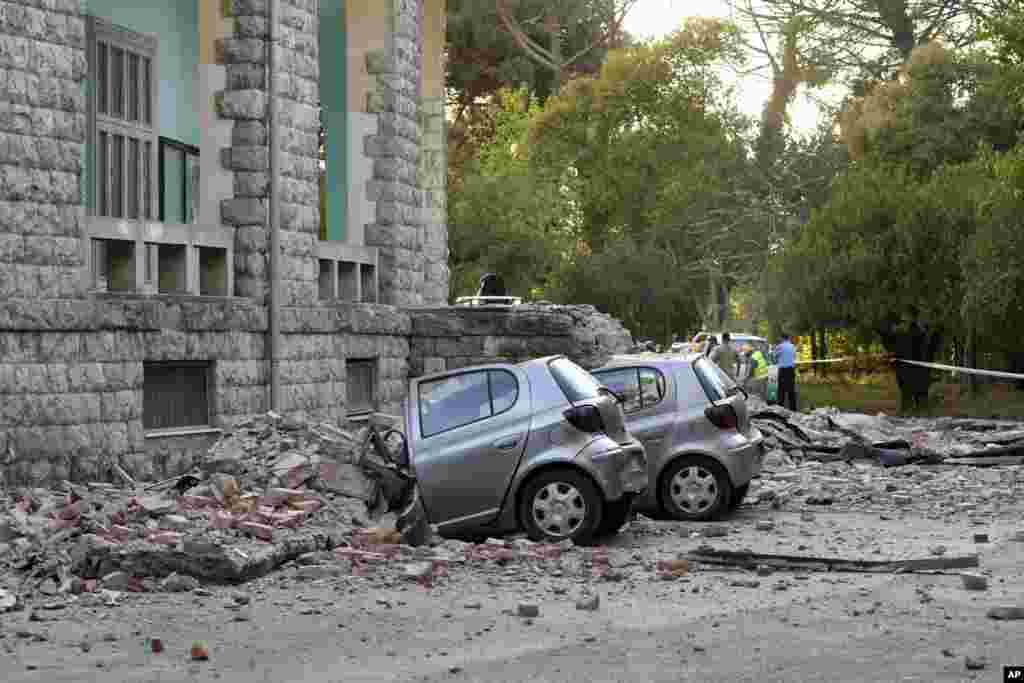 Damaged cars outside the Faculty of Geology building after an earthquake in Tirana, Sept. 21, 2019. Albania's government and news reports say an earthquake with a preliminary magnitude of 5.8 shook in the country's west and injured at least two people.