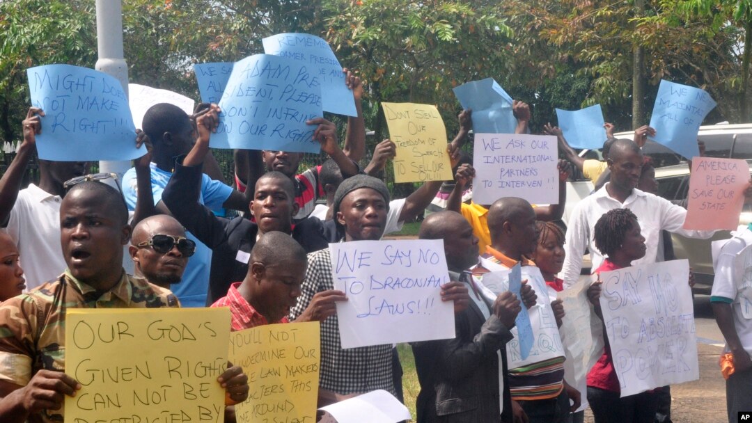FILE - Liberians stage a protest outside the National Assembly against the government not doing enough to fight Ebola virus in Monrovia, Liberia, Oct. 9, 2014.