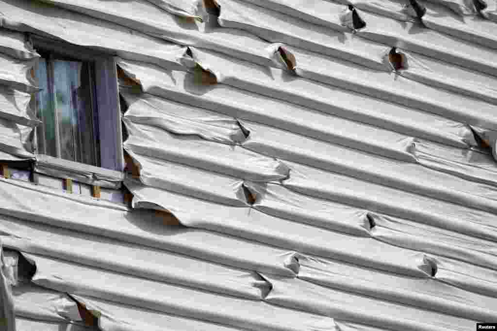 Melted siding on a home is seen near the scene of a train derailment in Lac Megantic, Quebec, July 7, 2013. 