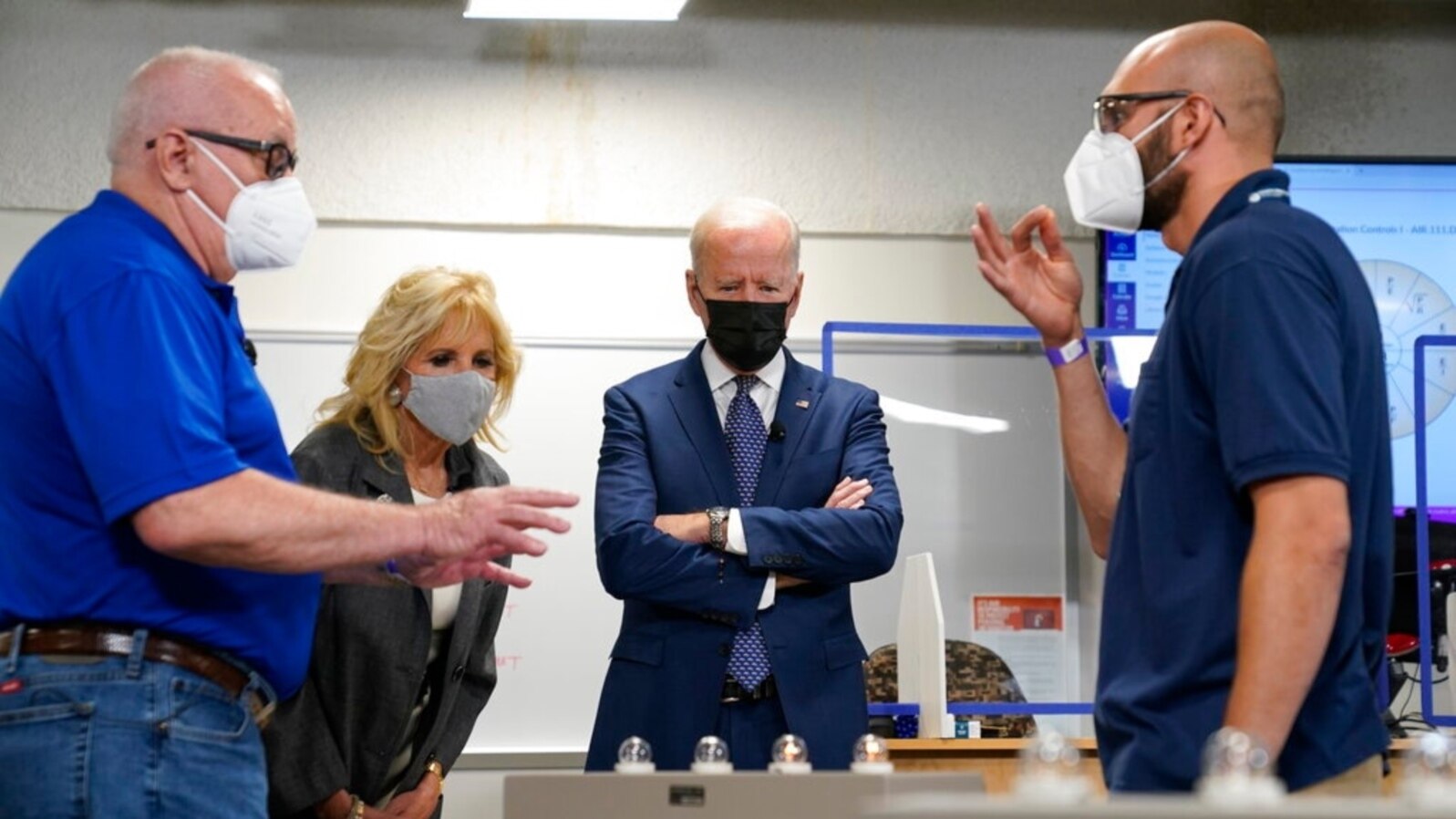President Joe Biden and first lady Jill Biden tour an HVAC workshop at Tidewater Community College, May 3, 2021, in Portsmouth, Va. Harlan "Skip" Krepcik, who teaches about heating, ventilation and air-conditioning systems, is at left. 