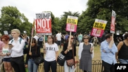Protesters against the visit of US President Donald Trump gather near an entrance to the US ambassador's residence Winfield House in Regents Park in London on July 12, 2018.