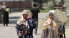 Thousands of refugees who had fled to Uzbekistan to avoid ethnic bloodshed trekked back to burned-out homes in Kyrgyzstan.
