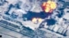 In this image made from undated video provided by Jordanian military via Jordan TV, explosions go off as the military carried out airstrikes at an undisclosed location in Syria. The military carried out airstrikes on Islamic State weapons depots and train