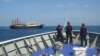 Philippines sends ships to disputed atoll, says China building 'artificial island'