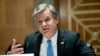 FBI Director Christopher Wray testifies before a Senate Homeland Security and Governmental Affairs Committee hearing to discuss security threats 20 years after the 9/11 terrorist attacks, Sept. 21, 2021 on Capitol Hill in Washington. 