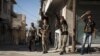 Free Syrian Army fighters train a gun on a Syrian war plane in the Bustan Pasha neighborhood of Syria's northern city of Aleppo, Aug. 23, 2012. 