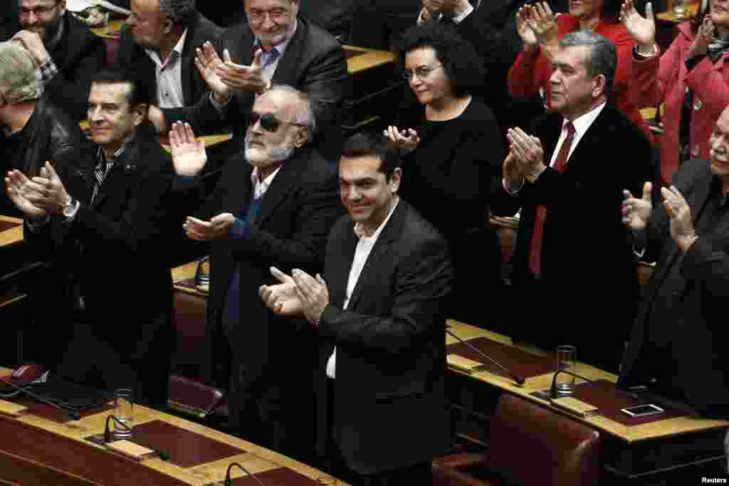 Alexis Tsipras, opposition leader and head of radical leftist Syriza party, and his party's lawmakers applaud after the last round of a presidential vote in Athens, Dec. 29, 2014. 