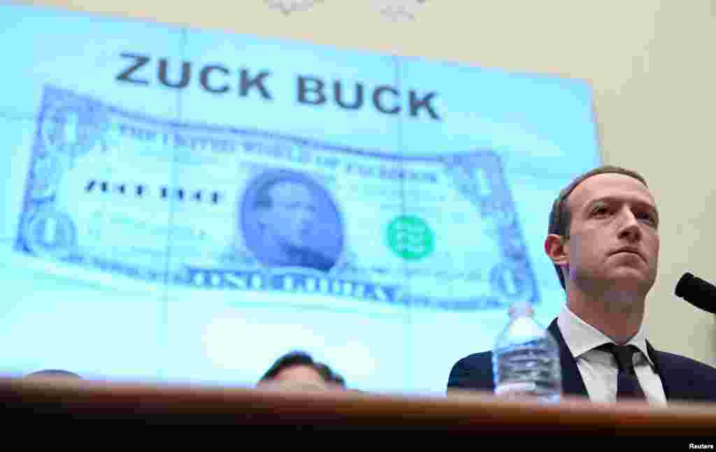 Facebook Chairman and CEO Mark Zuckerberg testifies in front of a projection of a "Zuck Buck" at a House Financial Services Committee hearing examining the company's plan to launch a digital currency on Capitol Hill in Washington, D.C.