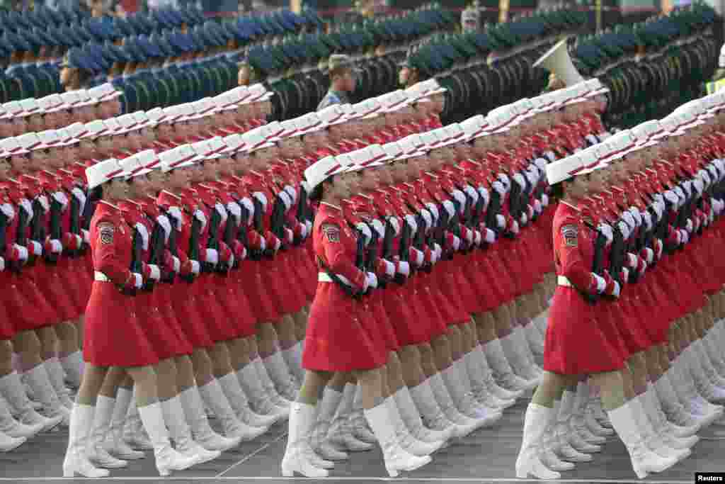 Militia members and soldiers of People's Liberation Army (PLA) march in formation past Tiananmen Square during a rehearsal before a military parade marking the 70th founding anniversary of People's Republic of China, on its National Day in Beijing, China.