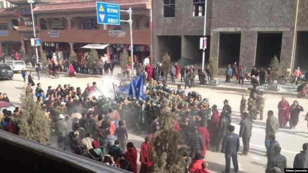 Citizen journalist image shows crowds surrounding Dorjee Rinchen, a Tibetan man who self-immolated in Labrang, China, October 23, 2012.