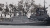 Seized Ukrainian ships, small armored artillery ships and a tug boat are seen anchored in a port of Kerch, Crimea, Nov. 26, 2018
