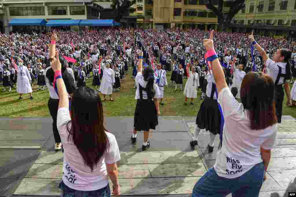 Students and nuns dance during global action on violence against women and children dubbed One Billion Rising, to coincide with Valentine's Day, at St. Scholastica's College in Manila.