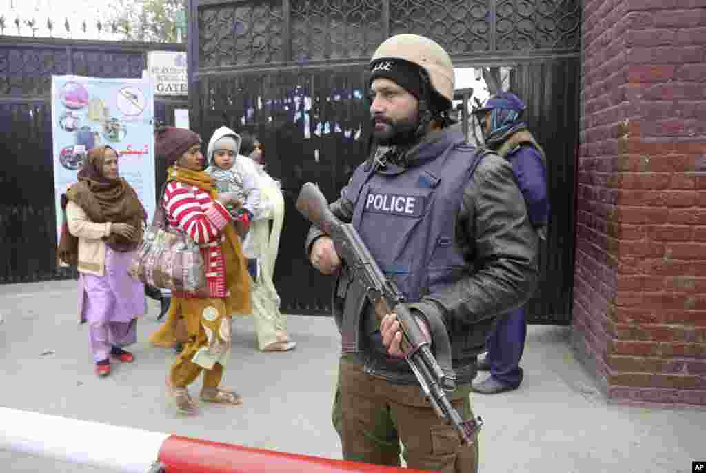 A police commando stands guard outside a church during Christmas Mass in Lahore, Pakistan.