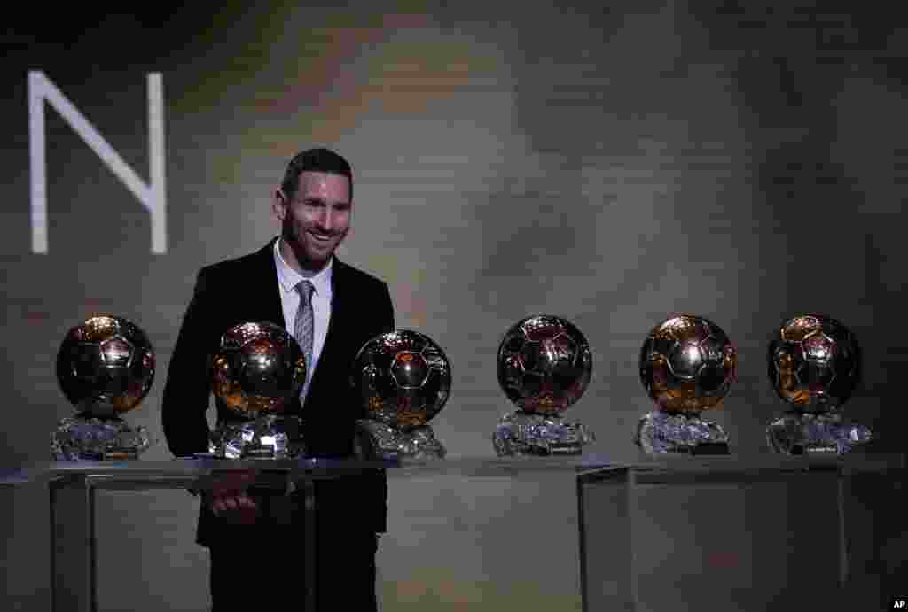 Barcelona's soccer player Lionel Messi poses with his six golden balls during the Golden Ball award ceremony in Paris, France, Dec. 2, 2019.