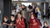 FILE - Afghan refugees arrive at Dulles International Airport on August 27, 2021, in Dulles, Virginia.