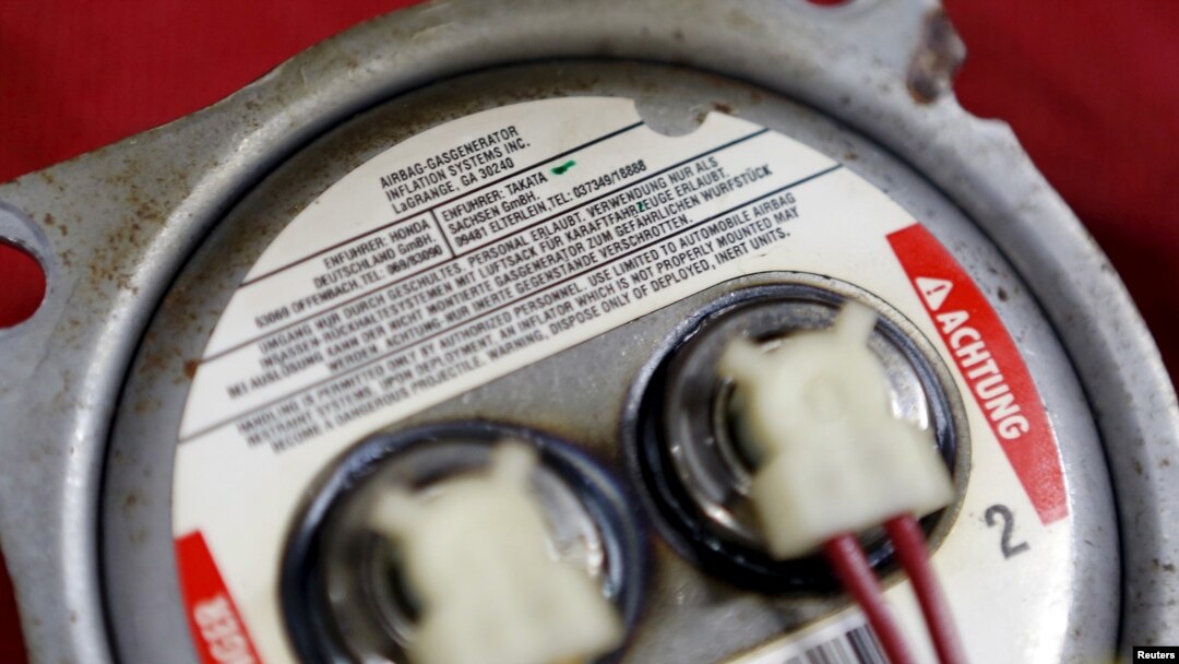 FILE - A recalled Takata airbag inflator is shown after it was removed at the AutoNation Honda dealership service department in Miami, June 25, 2015. 